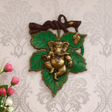 eCraftIndia Dancing Golden Lord Ganesha on Green Leaf Metal Wall Hanging